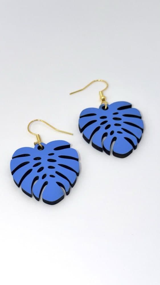 Blue wooden Monstera leaf earrings with an open-work design