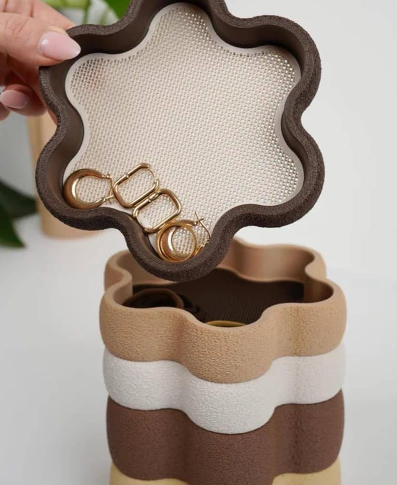 Round stackable jewellery trays holding rings and bracelets