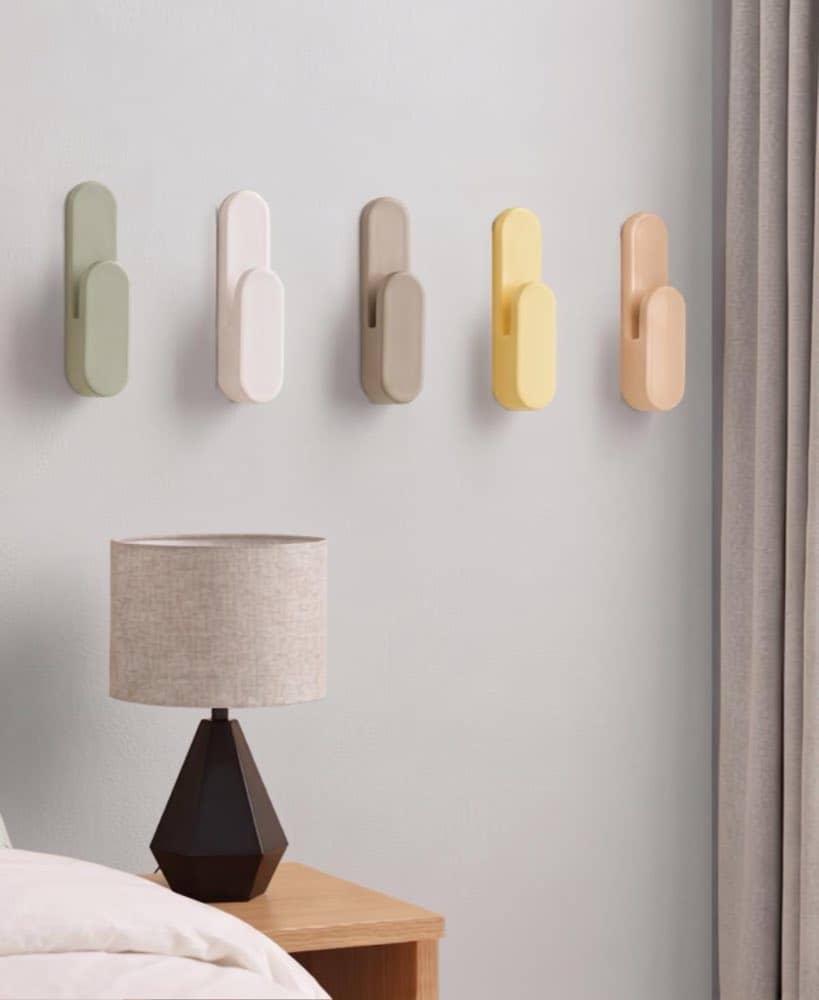 Set of minimalist wall hooks with soft curves mounted on a wall